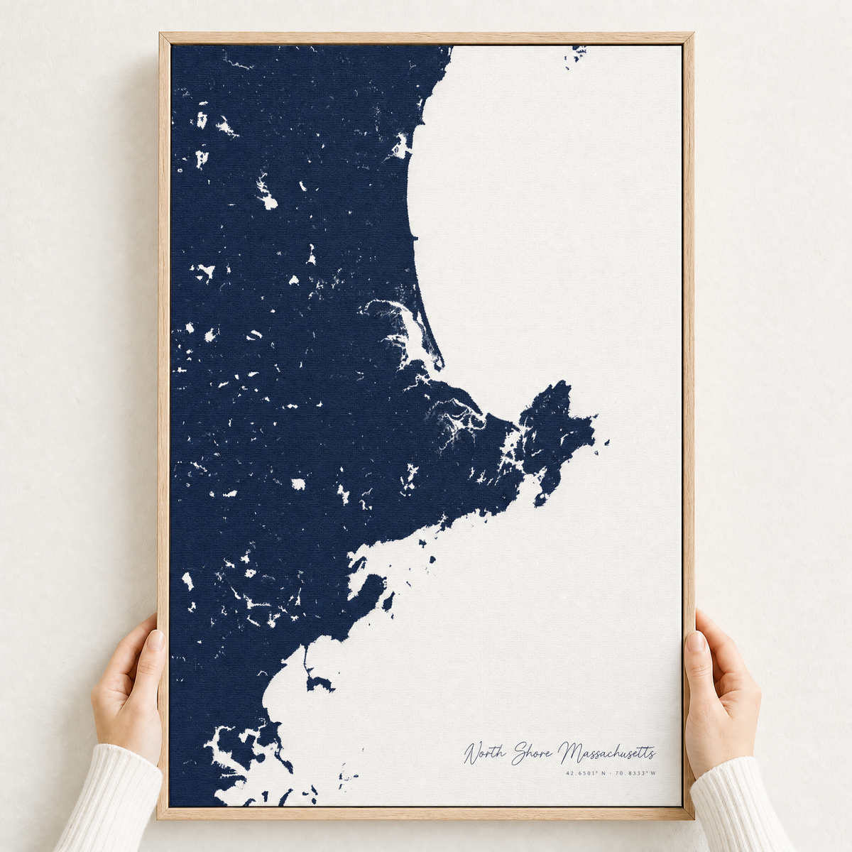 North Shore Massachusetts canvas map — hands holding the canvas in an oak frame