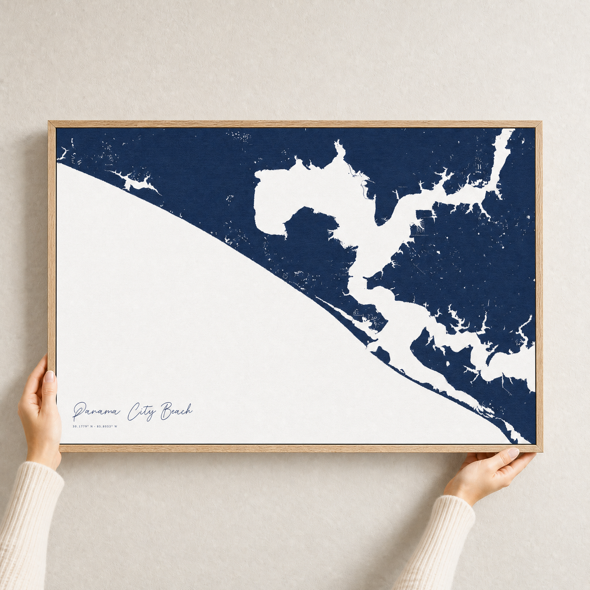 Panama City Beach canvas map — hands holding the canvas in an oak frame