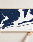 Pensacola canvas map — hands holding the canvas in an oak frame