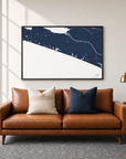 30A horizontal canvas map in Navy, black-framed canvas above a sofa