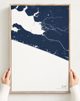 30A vertical canvas map in Navy, hands holding an oak-framed canvas
