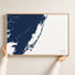 Assateague horizontal canvas map in Navy, hands holding an oak-framed canvas