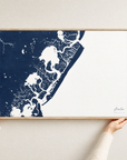 Avalon horizontal canvas map in Navy, hands holding an oak-framed canvas