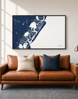 Avalon horizontal canvas map in Navy, black-framed canvas above a sofa