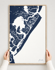 Avalon vertical canvas map in Navy, hands holding an oak-framed canvas