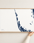 Captiva horizontal canvas map in Navy, hands holding an oak-framed canvas