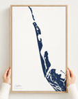 Captiva vertical canvas map in Navy, hands holding an oak-framed canvas