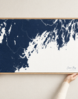 Casco Bay horizontal canvas map in Navy, hands holding an oak-framed canvas