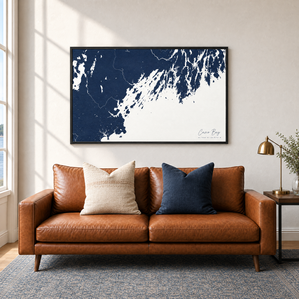 Casco Bay horizontal canvas map in Navy, black-framed canvas above a sofa