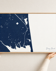 Dewey Beach horizontal canvas map in Navy, hands holding an oak-framed canvas
