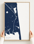 Dewey Beach vertical canvas map in Navy, hands holding an oak-framed canvas