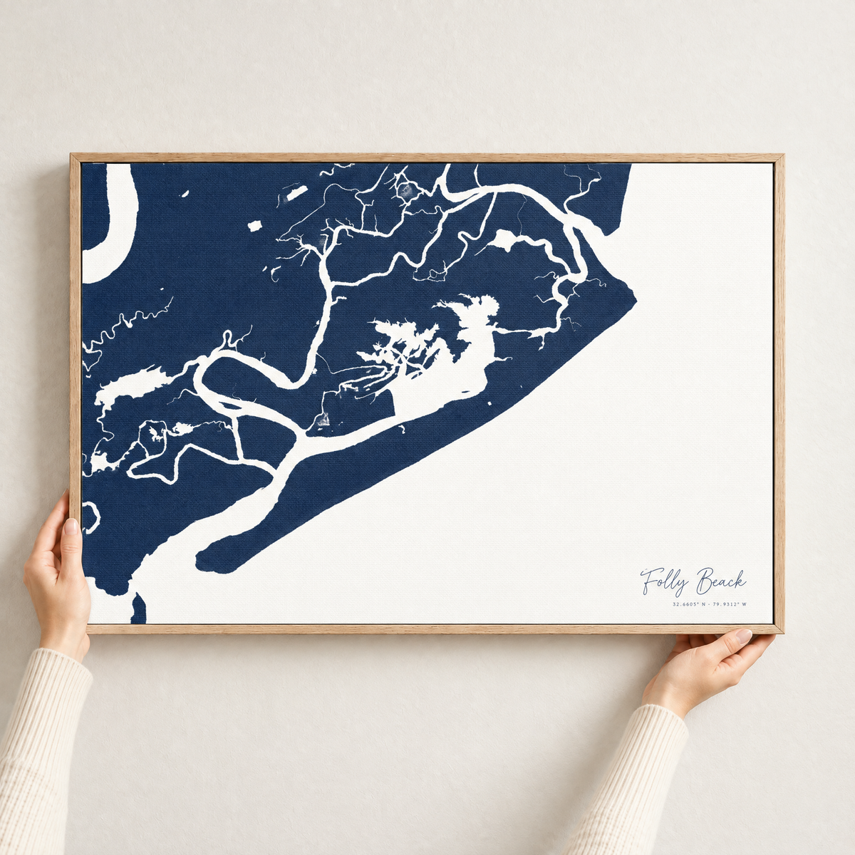 Folly Beach horizontal canvas map in Navy, hands holding an oak-framed canvas