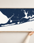 Gulf Shores horizontal canvas map in Navy, hands holding an oak-framed canvas