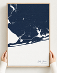 Gulf Shores vertical canvas map in Navy, hands holding an oak-framed canvas