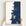 Hernando Beach vertical canvas map in Navy, hands holding an oak-framed canvas