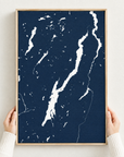 Lake George vertical canvas map in Navy, hands holding an oak-framed canvas