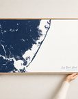Long Beach Island horizontal canvas map in Navy, hands holding an oak-framed canvas