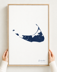 Nantucket vertical canvas map in Navy, hands holding an oak-framed canvas