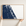 New Smyrna Beach horizontal canvas map in Navy, hands holding an oak-framed canvas