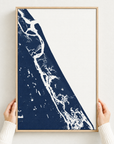 New Smyrna Beach vertical canvas map in Navy, hands holding an oak-framed canvas