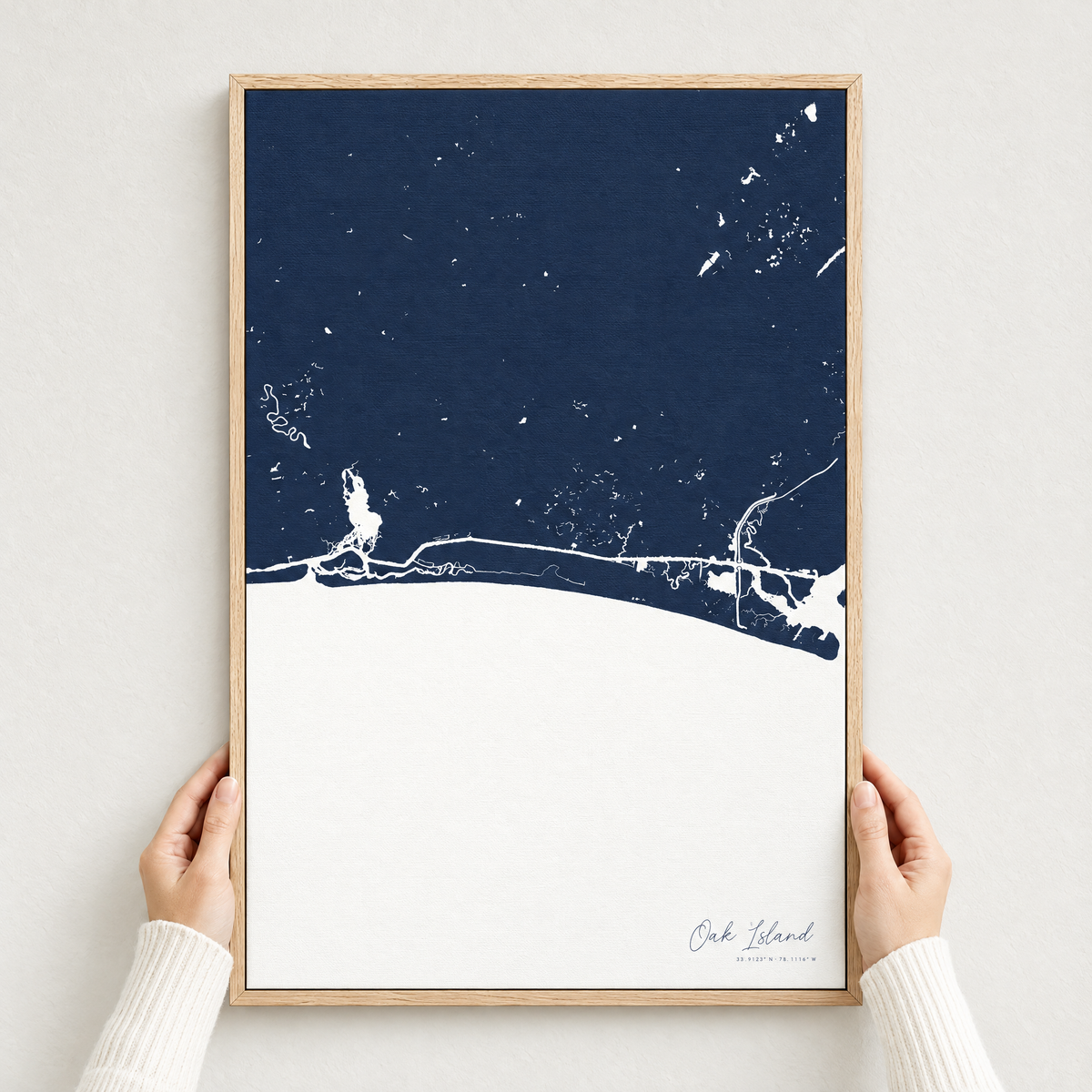 Oak Island vertical canvas map in Navy, hands holding an oak-framed canvas