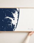 Ocean City horizontal canvas map in Navy, hands holding an oak-framed canvas
