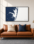 Ocean City horizontal canvas map in Navy, black-framed canvas above a sofa