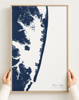 Ocean City vertical canvas map in Navy, hands holding an oak-framed canvas