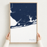 Orange Beach vertical canvas map in Navy, hands holding an oak-framed canvas