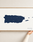 Puerto Rico horizontal canvas map in Navy, hands holding an oak-framed canvas