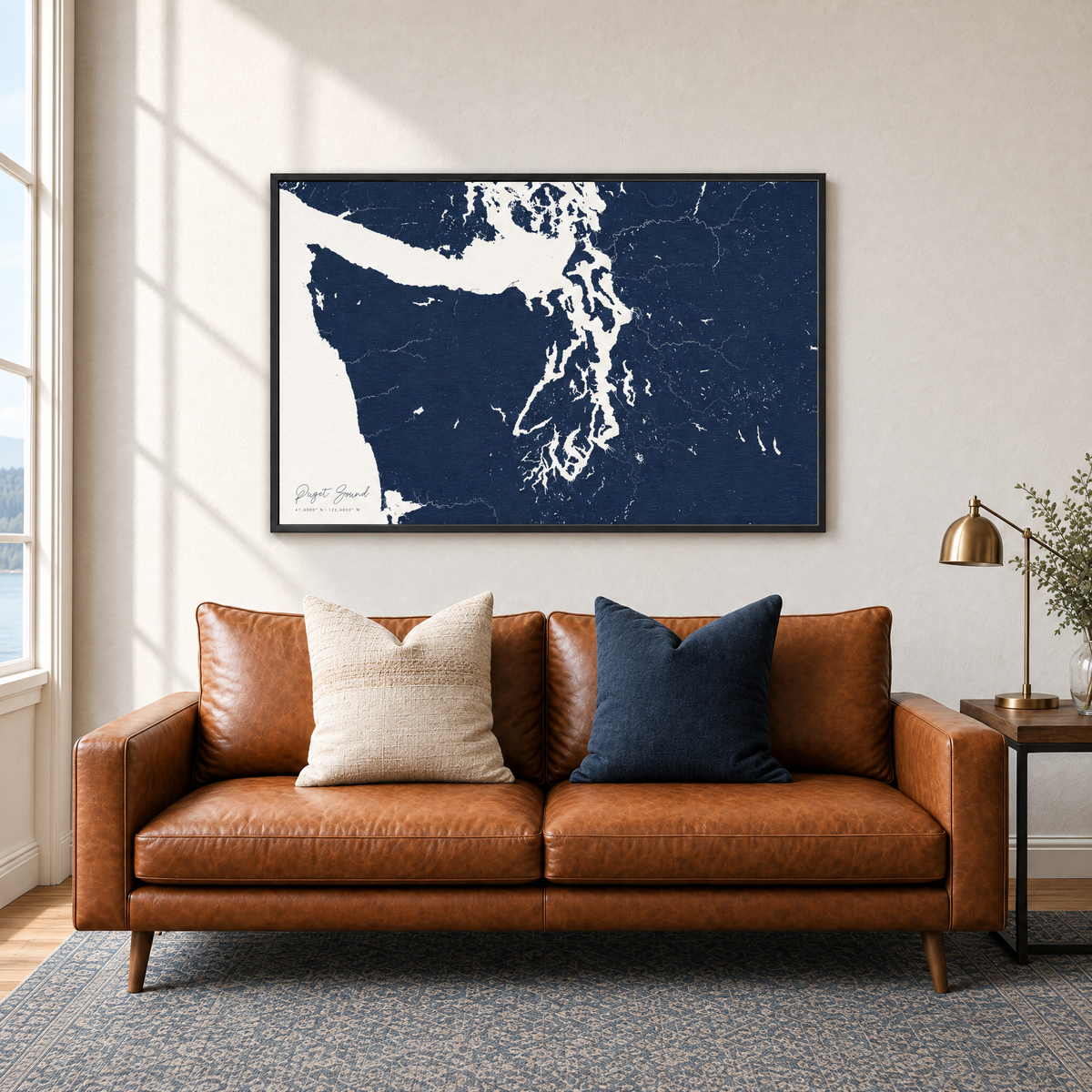 Puget Sound horizontal canvas map in Navy, black-framed canvas above a sofa