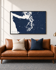 Puget Sound horizontal canvas map in Navy, black-framed canvas above a sofa