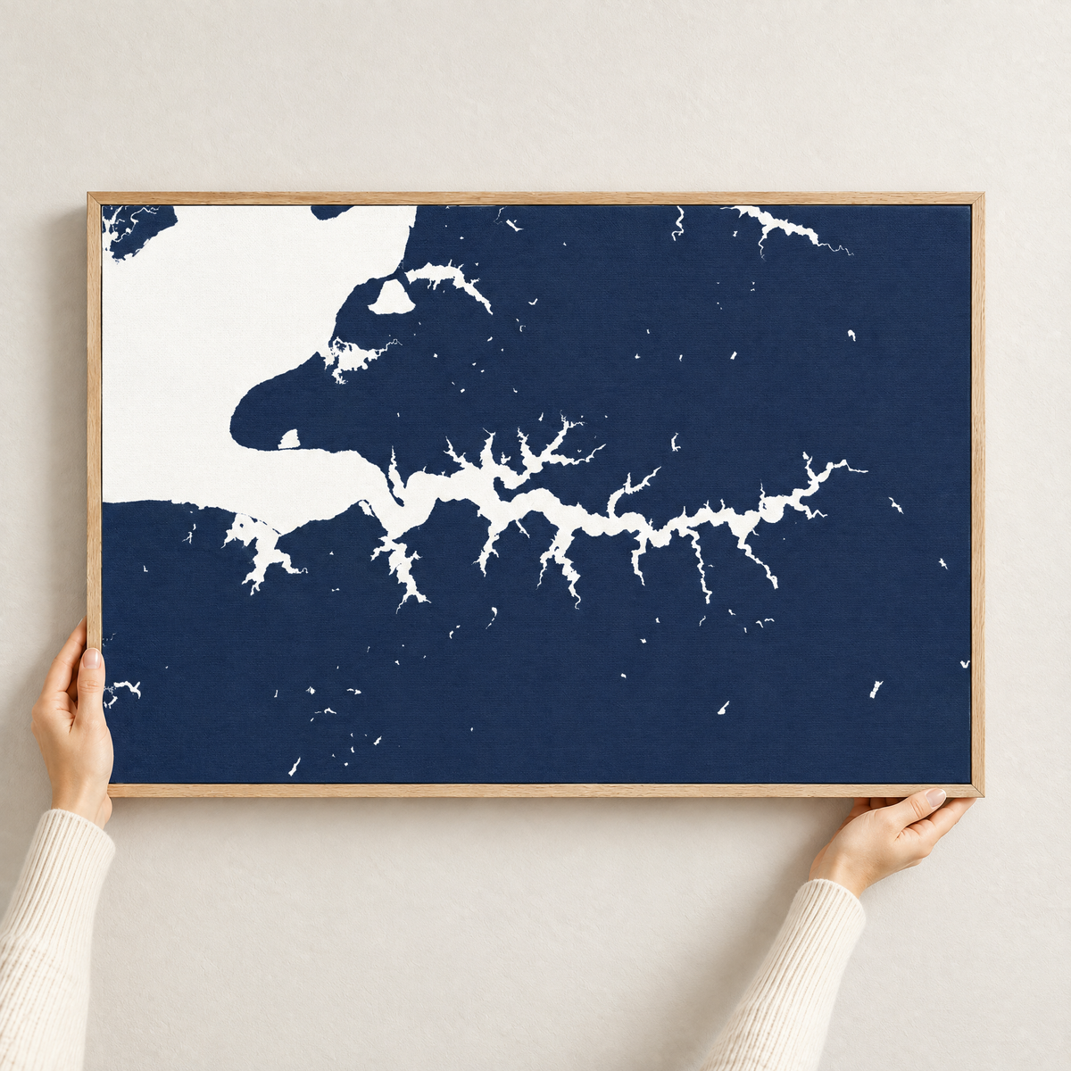 Sassafras River horizontal canvas map in Navy, hands holding an oak-framed canvas