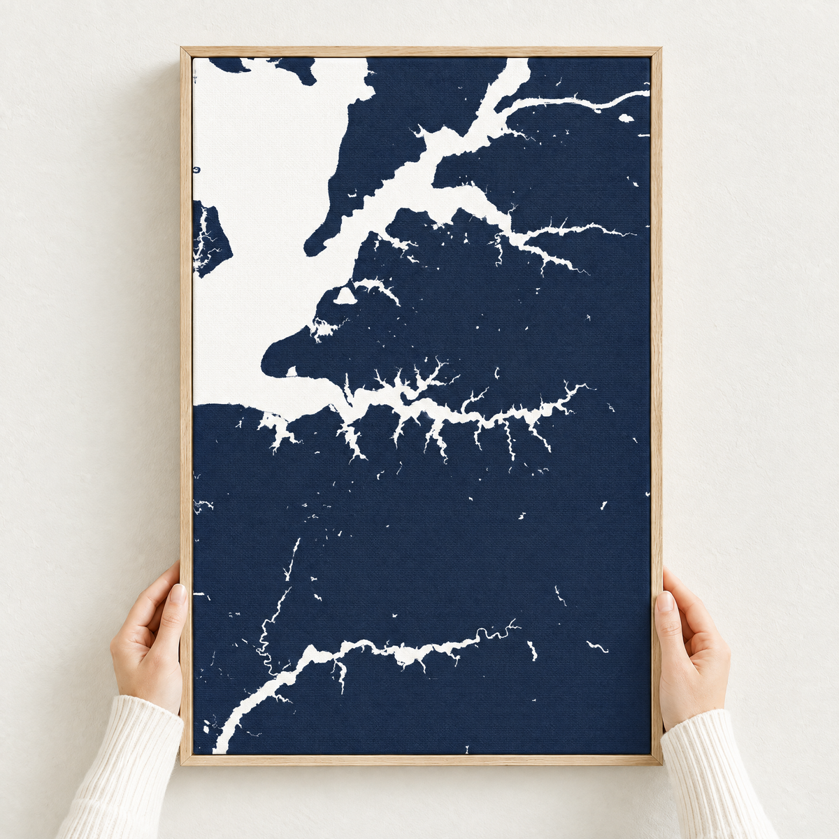 Sassafras River vertical canvas map in Navy, hands holding an oak-framed canvas