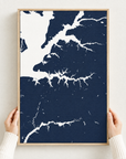 Sassafras River vertical canvas map in Navy, hands holding an oak-framed canvas