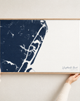 Wrightsville Beach horizontal canvas map in Navy, hands holding an oak-framed canvas