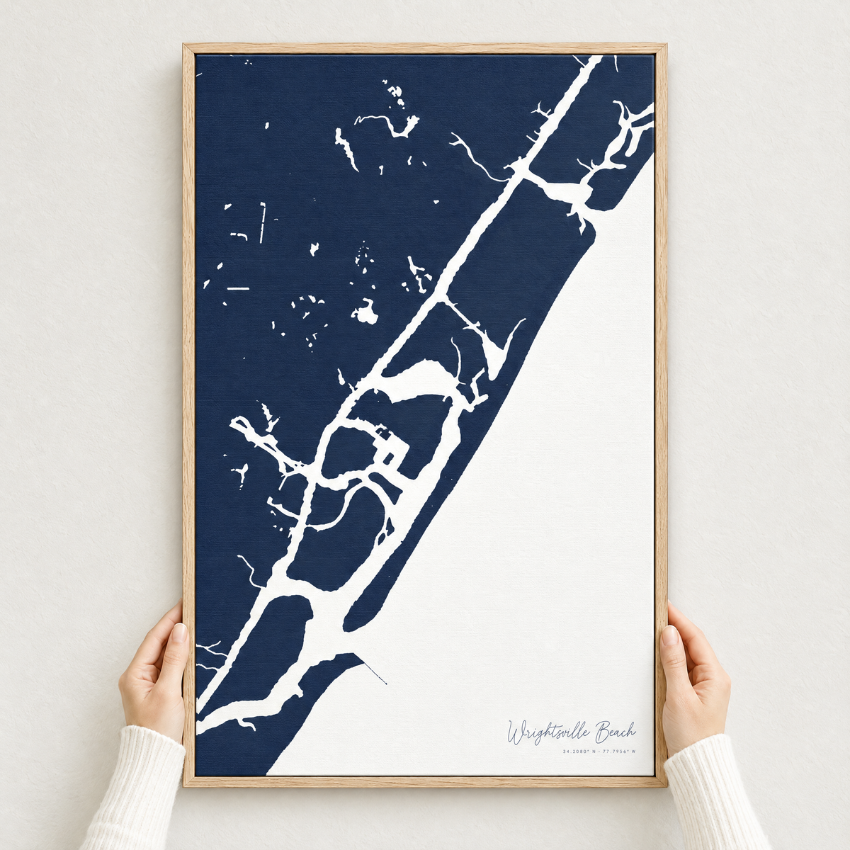 Wrightsville Beach vertical canvas map in Navy, hands holding an oak-framed canvas