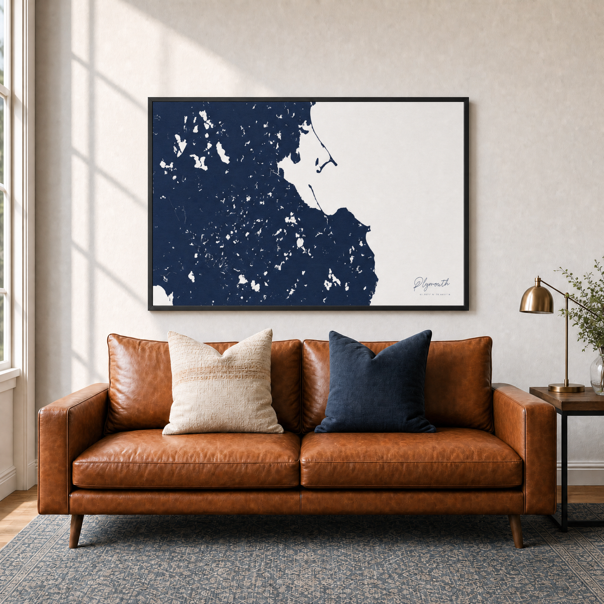 Plymouth canvas map — two-pillow black-frame sofa interior