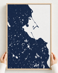 Plymouth canvas map — hands holding the canvas in an oak frame