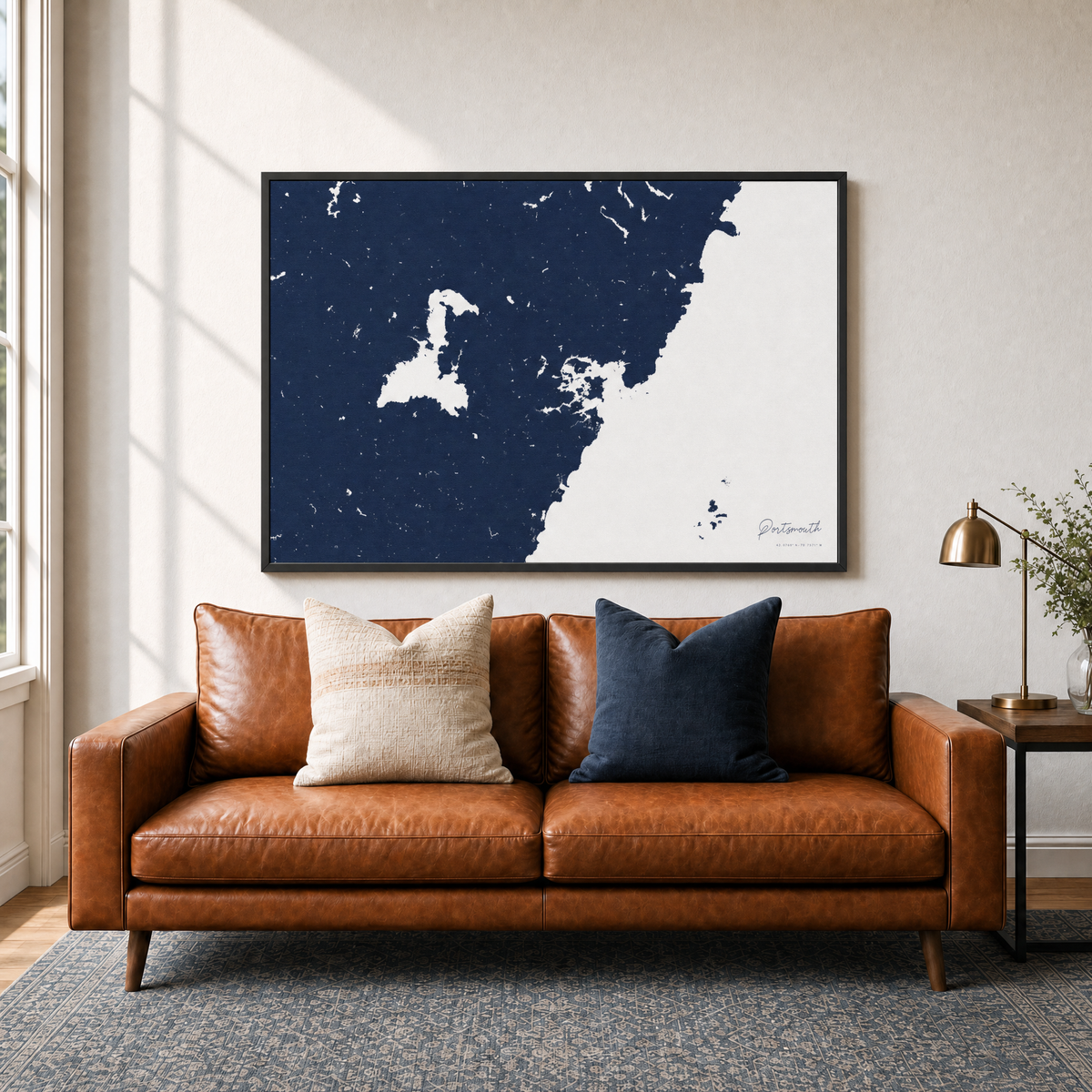 Portsmouth canvas map — two-pillow black-frame sofa interior