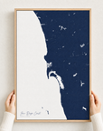 San Diego Coast canvas map — hands holding the canvas in an oak frame