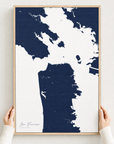 San Francisco canvas map — hands holding the canvas in an oak frame