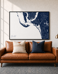 Sanibel canvas map — two-pillow black-frame sofa interior