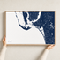 Sanibel canvas map — hands holding the canvas in an oak frame
