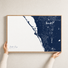 Siesta Key canvas map — hands holding the canvas in an oak frame