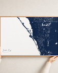 Siesta Key canvas map — hands holding the canvas in an oak frame