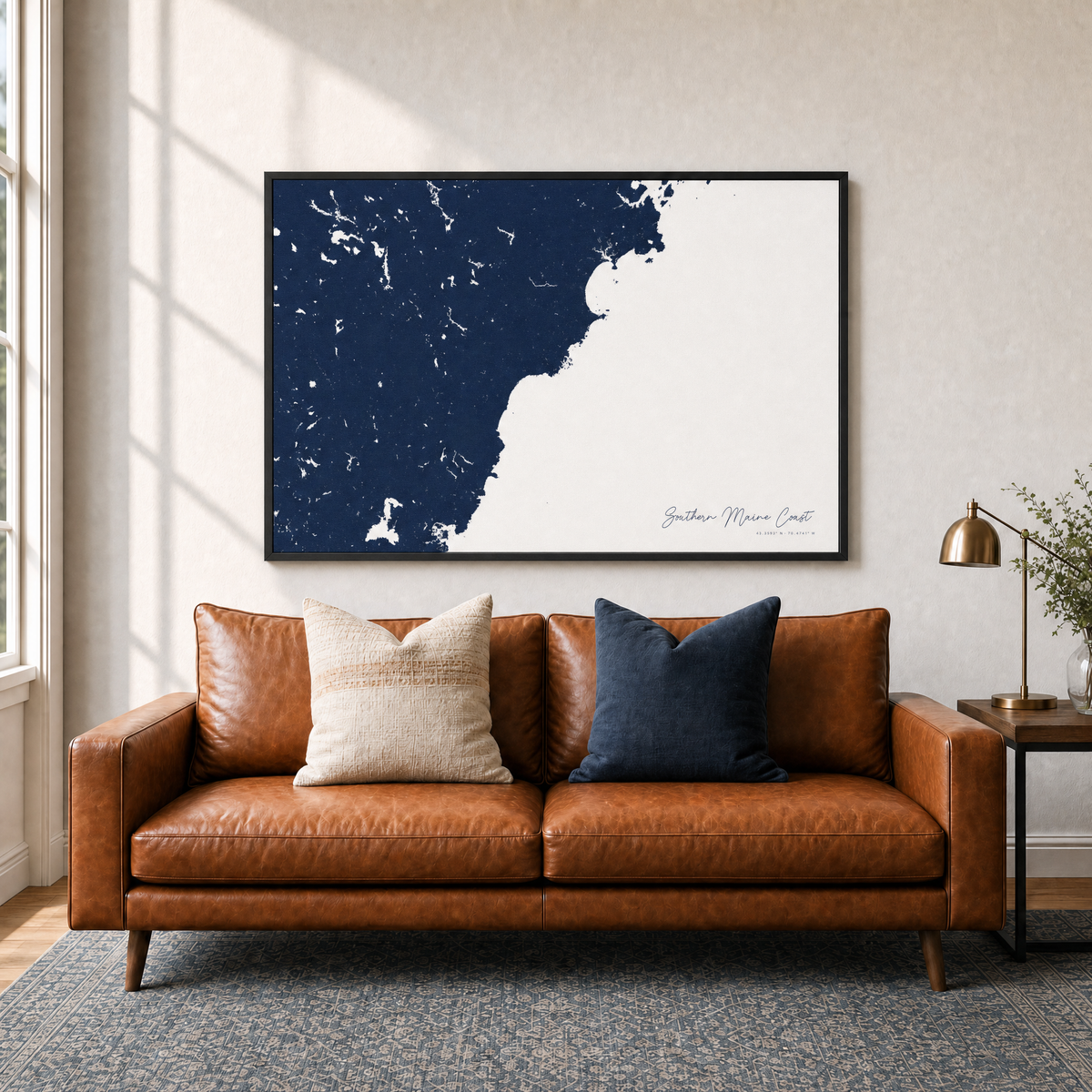 Southern Maine Coast canvas map — two-pillow black-frame sofa interior