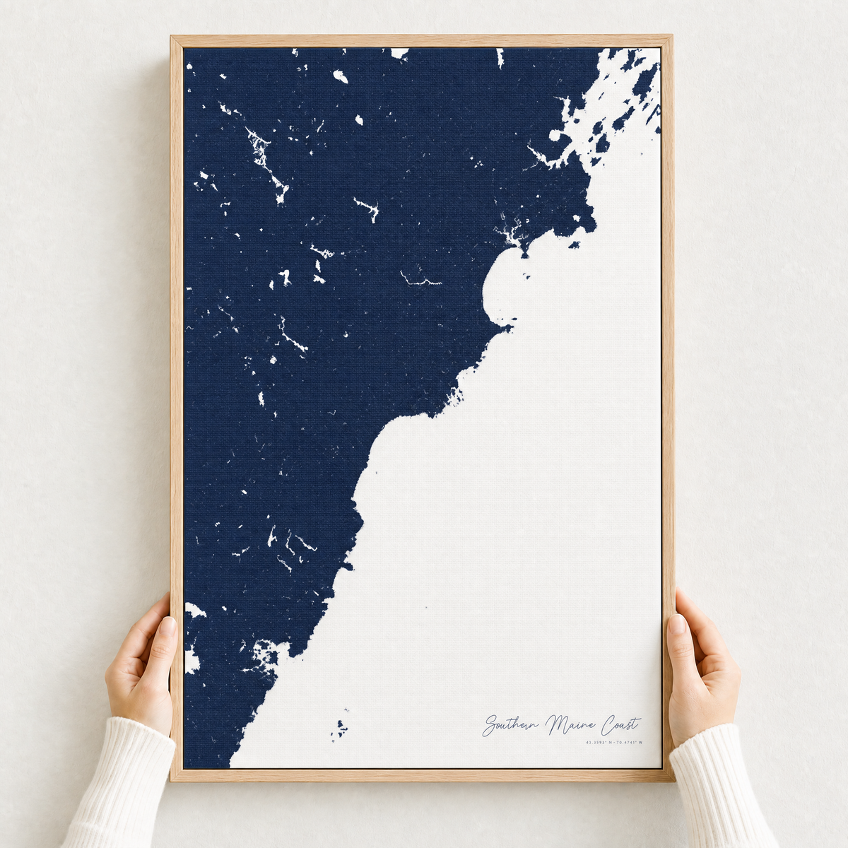 Southern Maine Coast canvas map — hands holding the canvas in an oak frame