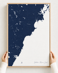 Southern Maine Coast canvas map — hands holding the canvas in an oak frame