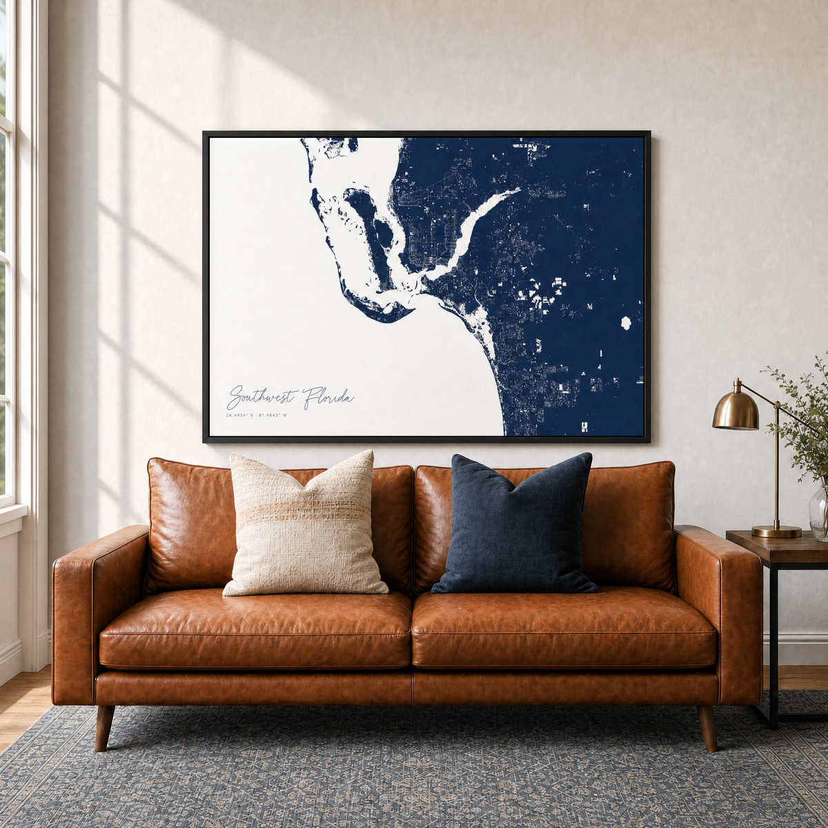 Southwest Florida canvas map — two-pillow black-frame sofa interior